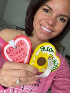 Woman holding hearts from a corporate team-building event.